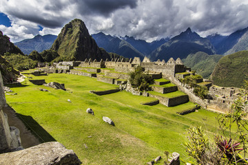 Fototapeta na wymiar Machu Picchu maybe one of the most visited places in south america and it deserves it. Steep walls with impressive valleys and mountains surround the old city of the Inca Empire