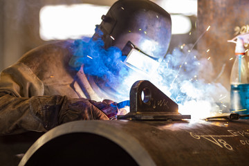 Welding worker in industry