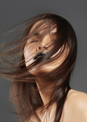Fashion Model with Long Blowing Hair. Glamour Asian Beautiful Woman with Beautiful Brown Hair. Fashion Style, Clean Skin