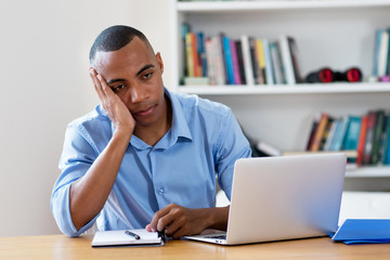 Fototapeta premium Stressed african american man at computer