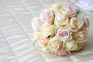 
Beautiful roses bouquet laying on the bed