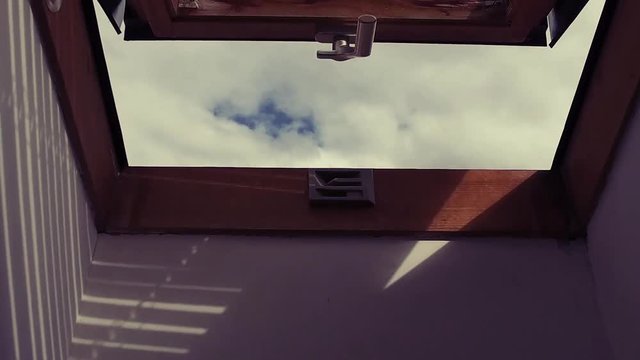 Beautiful nature view through roof skylight window in attic room, vintage