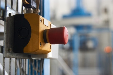 Start or stop button for industrial machine, close-up. Emergency Stop for Safety concept. Red...