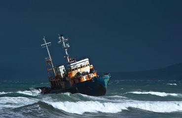 A coast guard ship wrecked on the severe coast.