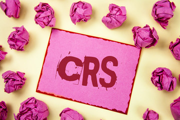 Writing note showing  Crs. Business photo showcasing Common reporting standard for sharing tax financial information written on Pink Sticky Note Paper on plain background Pink Paper Balls.
