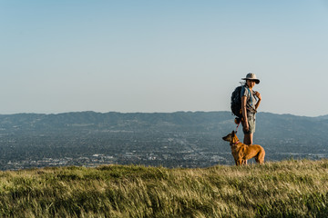 Dog and girl on a hilltop