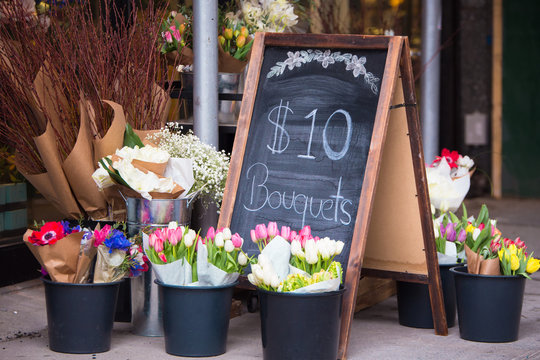 Charming florist sidewalk display of flowers and sign
