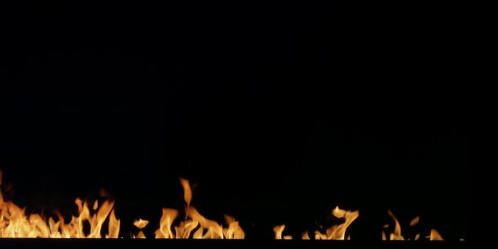 A blaze grows rapidly from flames flickering below the bottom of the frame