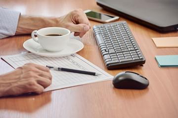 Closeup photo of businessman working with documents in modern office