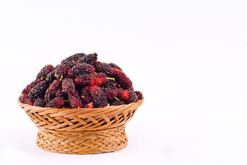 fresh organic mulberries in brown basket on white background healthy mulberry fruit food isolated
