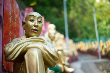 A Bhuddist statue during a walk up the steps at the Ten Thousand Bhuddhas Monastery, Hong Kong Asia