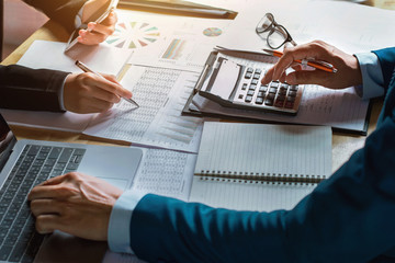 Men doing business calculation at table