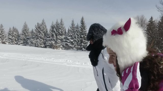 Portrait of happy family mother and daughter on a winter hike walk outdoors. Having fun and joy with smiling expresion 
