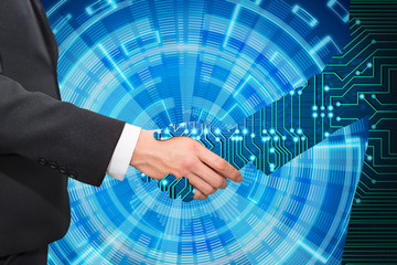 Businessman shaking hand with digital partners hand on blue futuristic background.