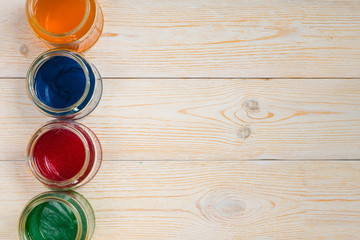 glass jars in line with different paints