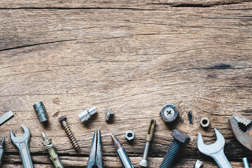 Variety Handy Tools on grunge wooden background. Top view close up of wrenches, Pliers,...