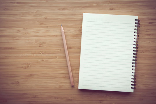 Blank notebook on desk background.