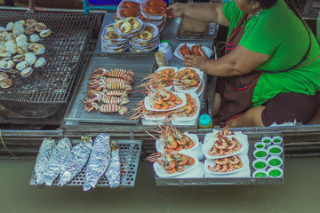 Famous floating market in Amphawa Thailand, Floating Market, tourists visiting by boat, Samutsongkrami, Thailand.