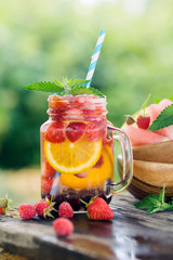 Fresh fruit and berry water in glass jar. Summer drinks