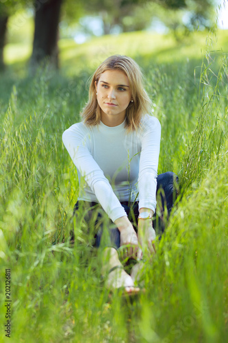 Attractive Young Blonde Caucasian Woman In Tight White Top