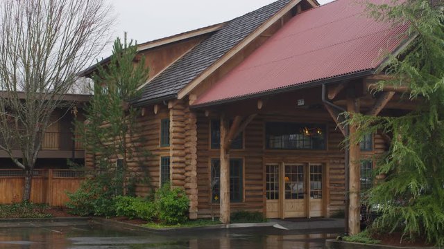 Right pan over the portico of a rustic lodge in Grants Pass, Oregon