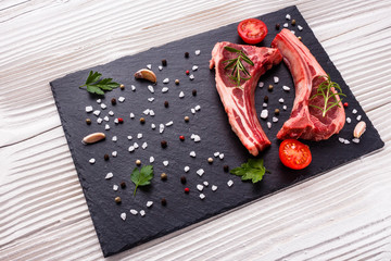 fresh lamb meat on a textured stone plate