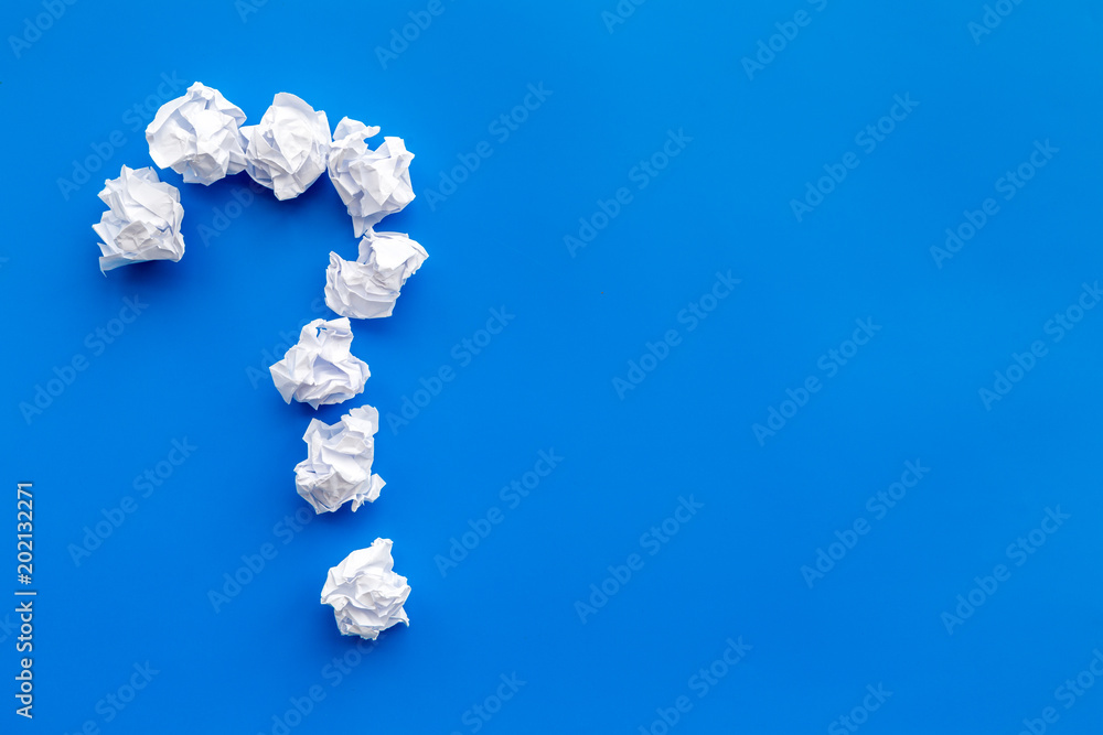 Poster question mark lined with crumpled paper on blue background top view copy space