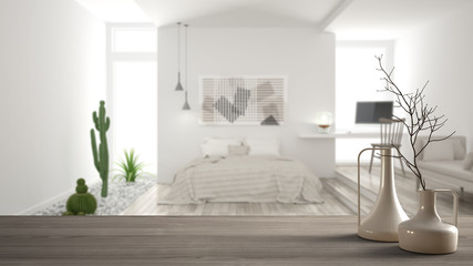 Wooden table top or shelf with minimalistic modern vases over blurred minimalist modern bedroom, white interior design