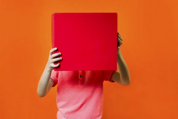 funny boy holding a box on an orange background