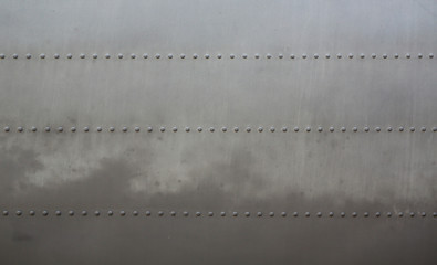 Metal surface background of military aircraft with cover.
