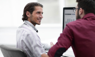 smiling employee talking with a colleague