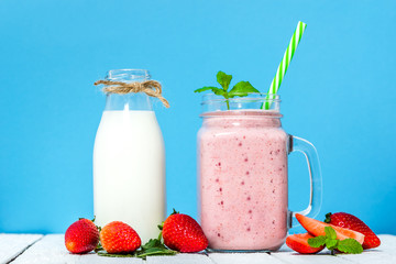Jar of milkshake with strawberries or smoothie with fresh strawberry and milk, healthy food concept