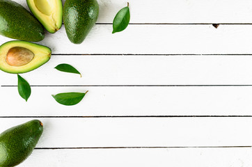 Fresh avocado on white wooden background
