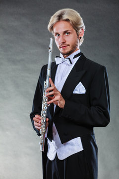 Elegantly dressed musician holding flute