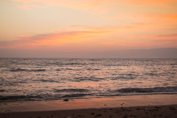 Fototapeta na wymiar Orange sunset over the sea and wave. Nature composition