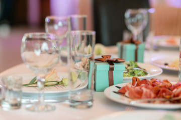 gift box with ribbons. Luxury wedding reception in restaurant. stylish decor and adorning. Restaurant table with food