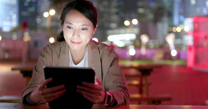 Asian Business woman use of digital tablet computer at night