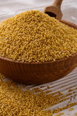 bowl of millet on a white wooden background