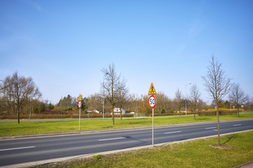 Road with 50 km per hour speed limit signs.