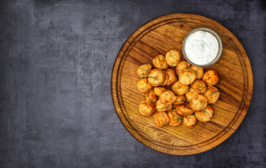 Dumplings stuffed with meat sprinkled with fresh herbs , top view, black background