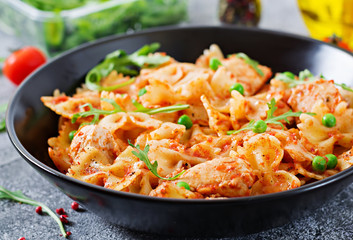 Farfalle pasta with chicken fillet, tomato sauce and green peas.   Food menu