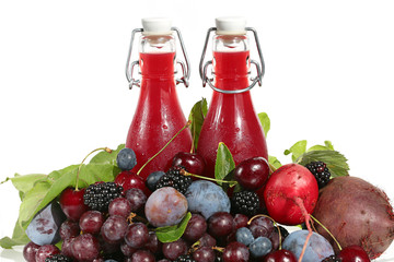 fruit vegetable smoothies.bright burgundy smoothies in glass bottles made from fresh cherries, grapes, plums, blackberries, beets on white background. Super   food