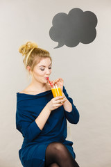 Happy woman holding fresh orange juice