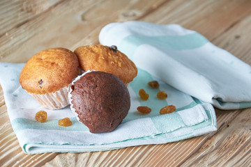 Tasty muffins arranged in pattern on light textured background, close-up, shallow depth of field, selective focus.