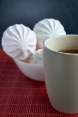 White and pink zephyr marshmallow with cap of tee on porcelain plate