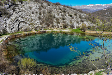 Blue oasis surrounded whit mountain/ Mountain scenery with meadows, peaks and glacier lakes in Croatia, beautiful view at river Cetina- Blue Eye,