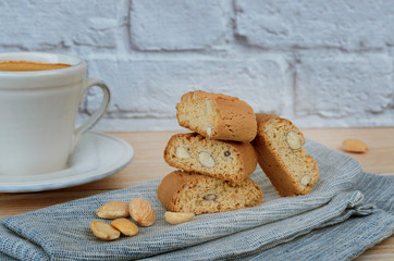 Homemade biscotti cantuccini, Italian almond sweets biscuits with  cup of coffee  on woodem table. Fresh Italian cookies cantucci background.