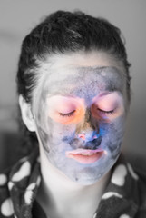 woman with mud mask looking like the victim of domestic violence