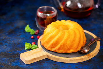 Biscuit cake with icing sugar, a cranberry and mint
