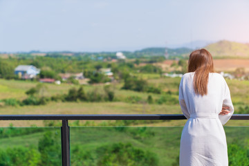 A woman standing look mountain view background.